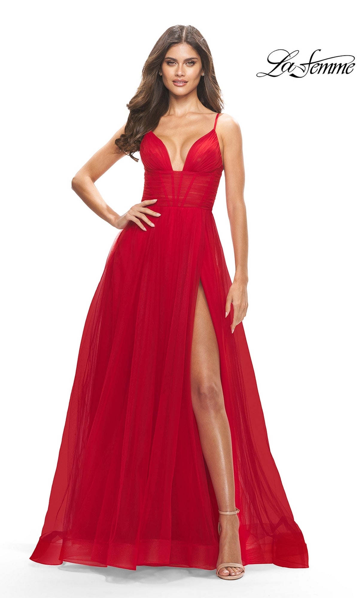 Woman wearing a red Sheer-Waist La Femme Long Prom Ball Gown 31147, featuring spaghetti straps, deep V neckline, sheer bodice, and high slit.